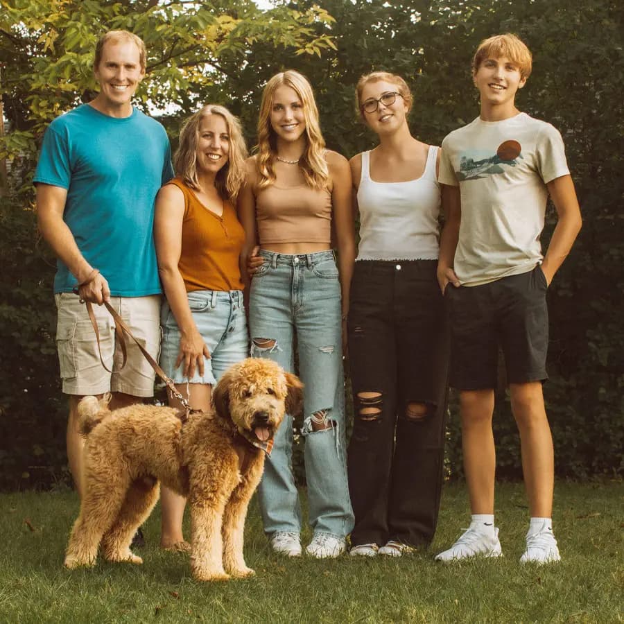 Katie M outdoors with her husband, her three teenagers and their dog